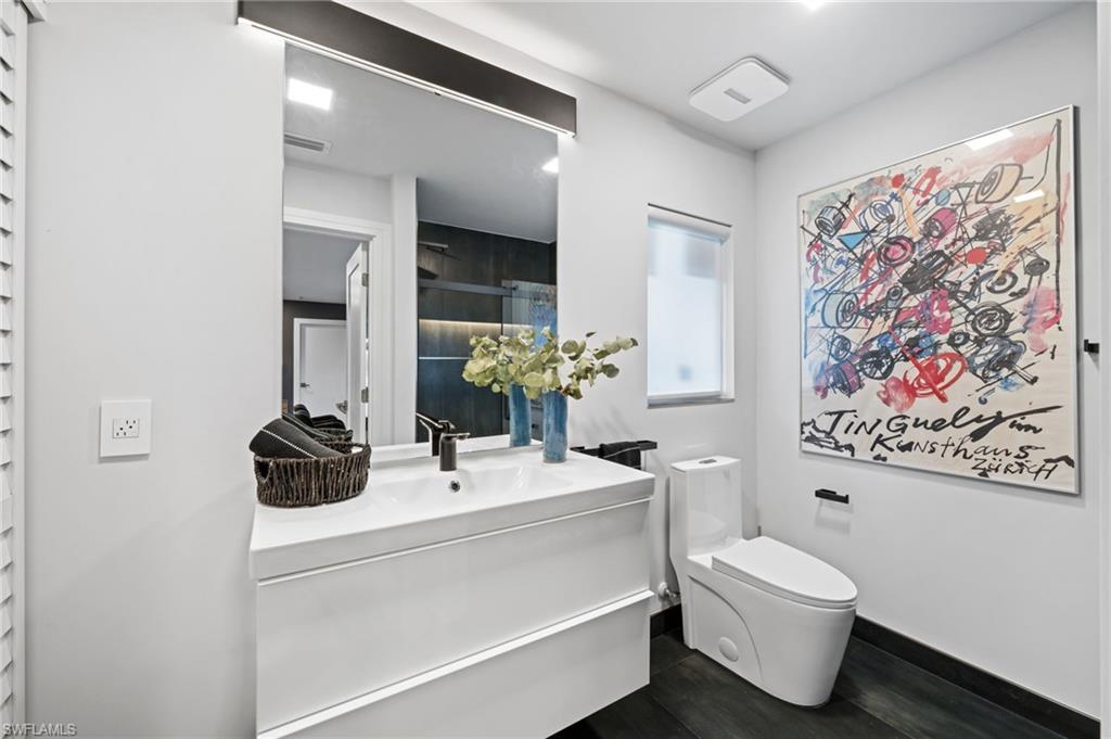 304 Nason Lane Naples, FL 34112 - Photo 23 of 43 a bathroom with a sink mirror and toilet