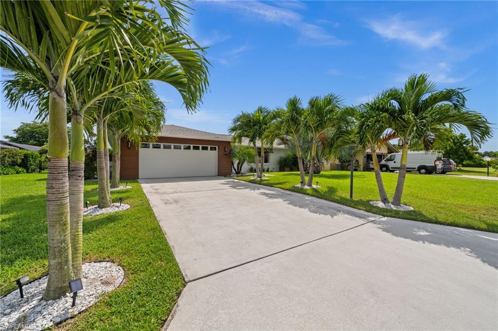 304 Nason Lane Naples, FL 34112 - Photo 29 of 43 a view of a house with a yard and palm trees