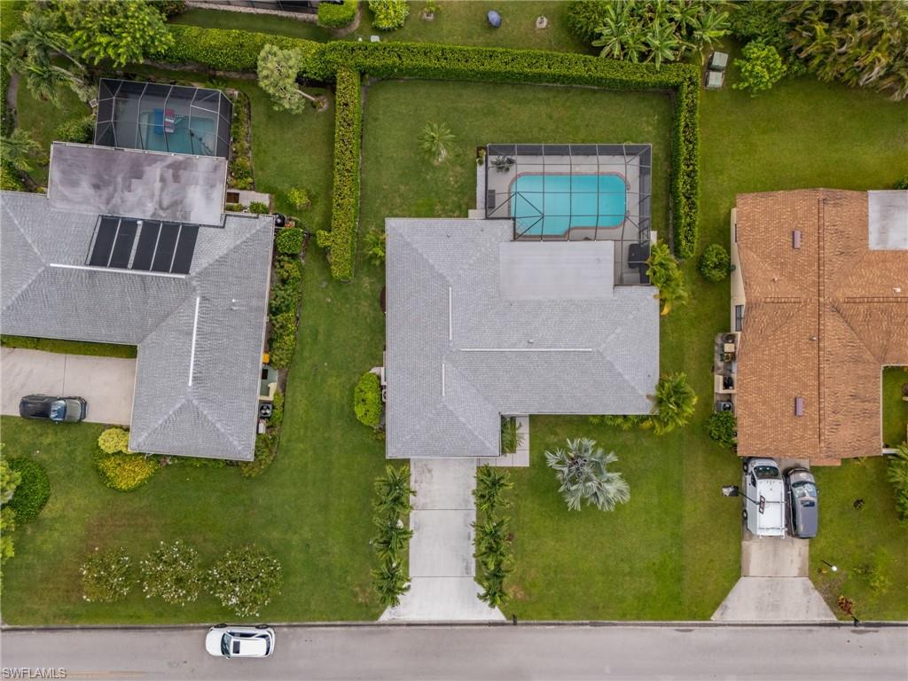304 Nason Lane Naples, FL 34112 - Photo 30 of 43 an aerial view of a house with outdoor space lake view and a building in the background