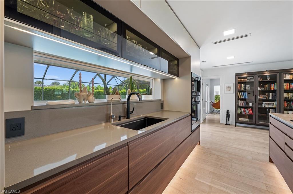 304 Nason Lane Naples, FL 34112 - Photo 3 of 43 a kitchen with stainless steel appliances a sink and cabinets