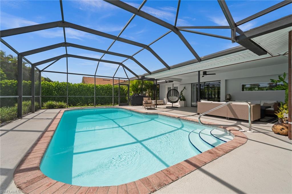 304 Nason Lane Naples, FL 34112 - Photo 34 of 43 a view of a swimming pool with a patio
