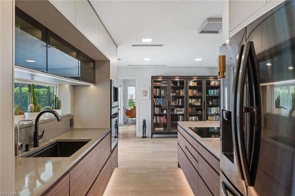304 Nason Lane Naples, FL 34112 - Photo 5 of 43 a kitchen with stainless steel appliances granite countertop a sink and a refrigerator