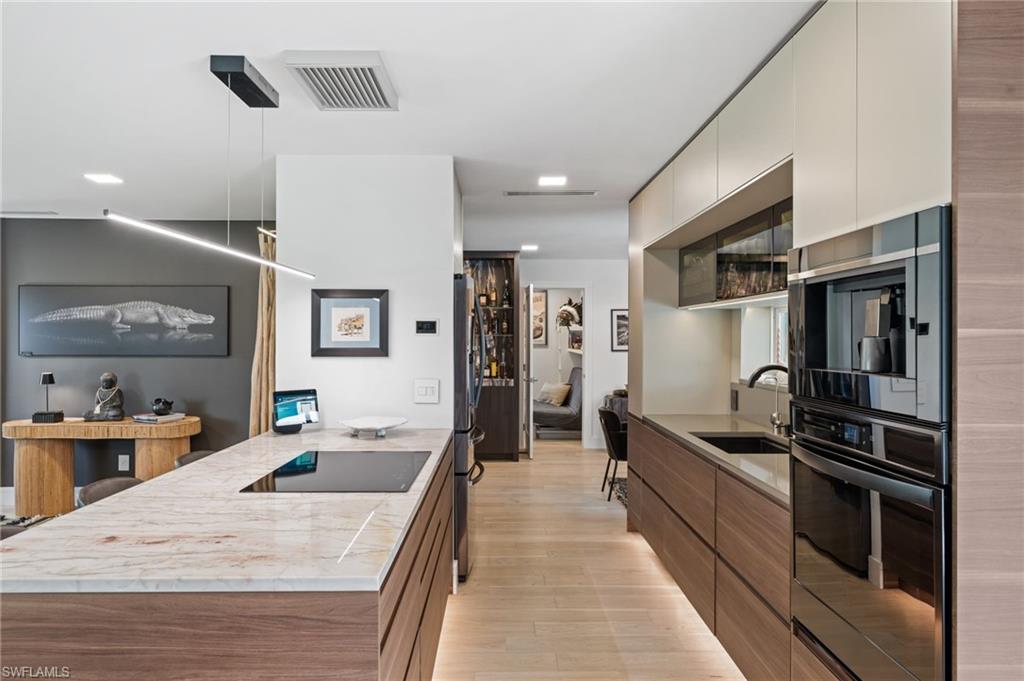 304 Nason Lane Naples, FL 34112 - Photo 6 of 43 a kitchen with stainless steel appliances kitchen island granite countertop a sink and refrigerator