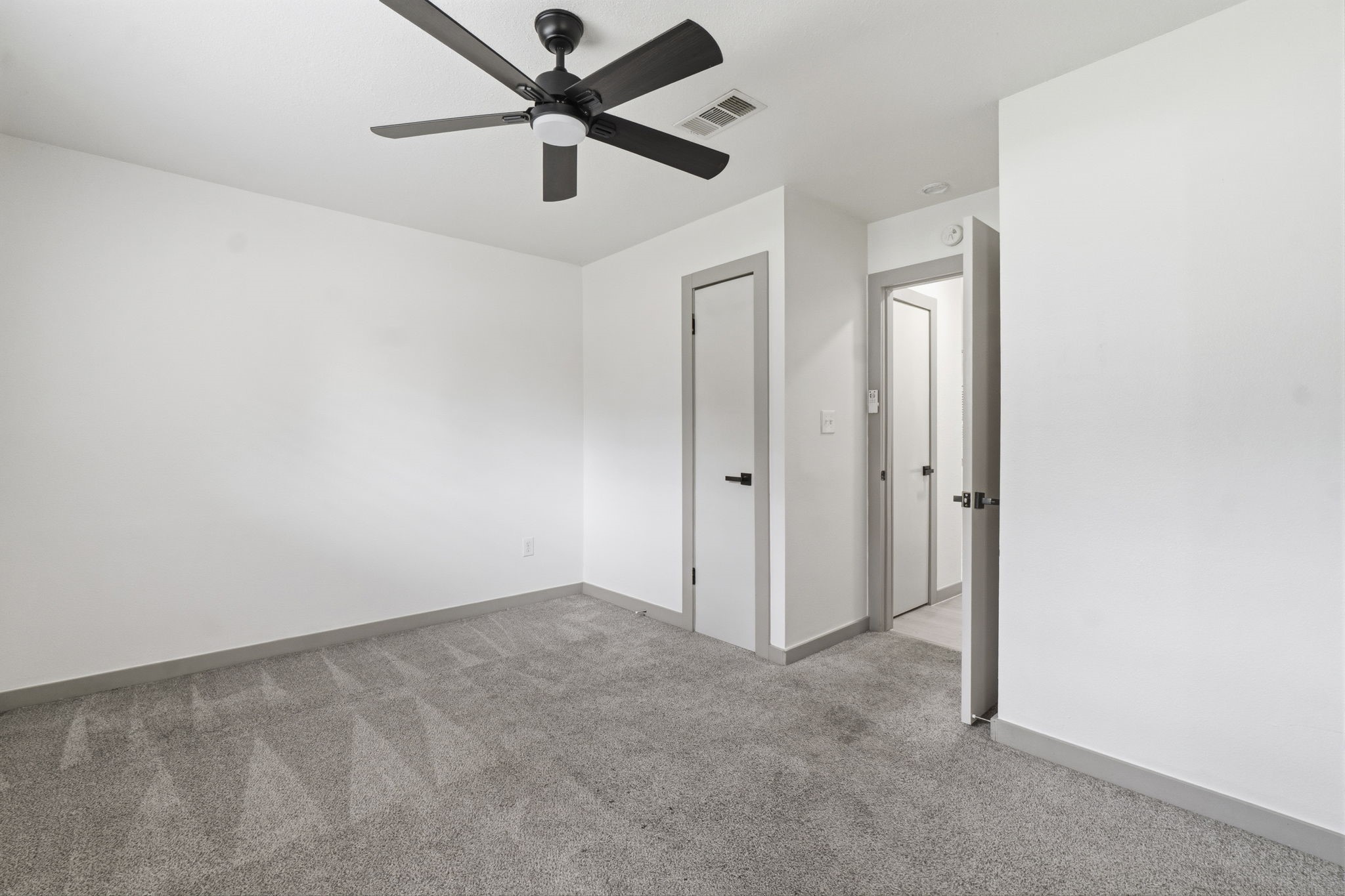 14850 Coaltown Road Willis, TX 77378 - Photo 23 of 41 Bright and inviting primary bedroom offering a comfortable layout with modern finishes and private bath access.