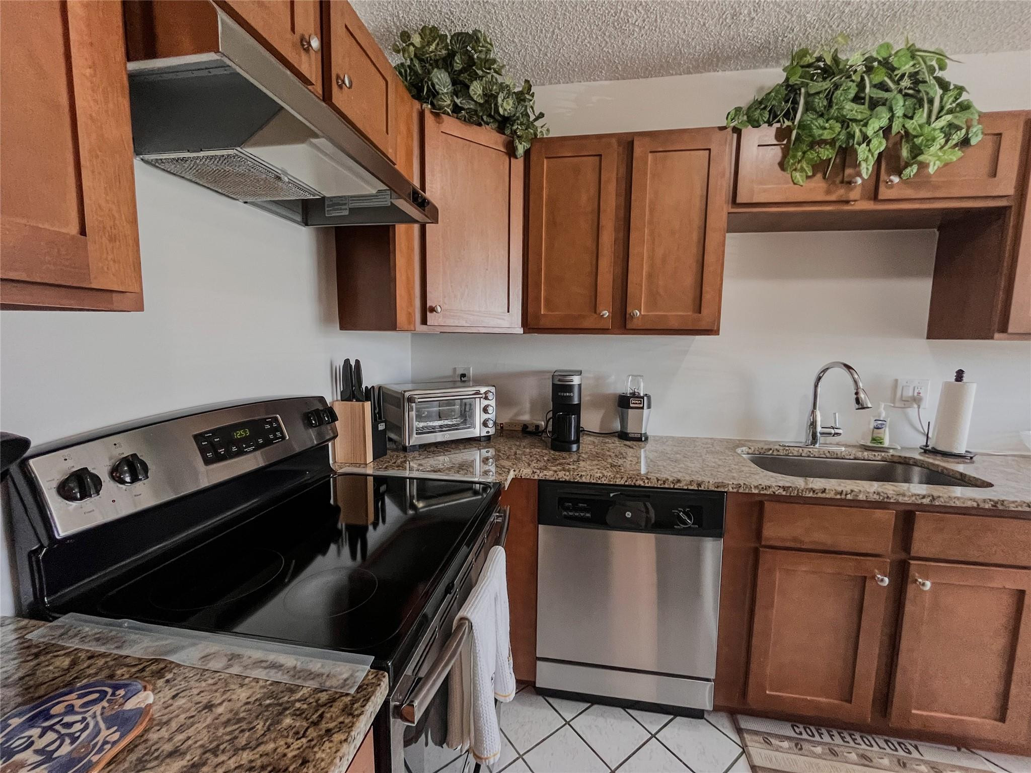 20932 Sedgewick Drive, Unit 400 Boca Raton, FL 33433 - Photo 13 of 34 a kitchen with a stove microwave and sink