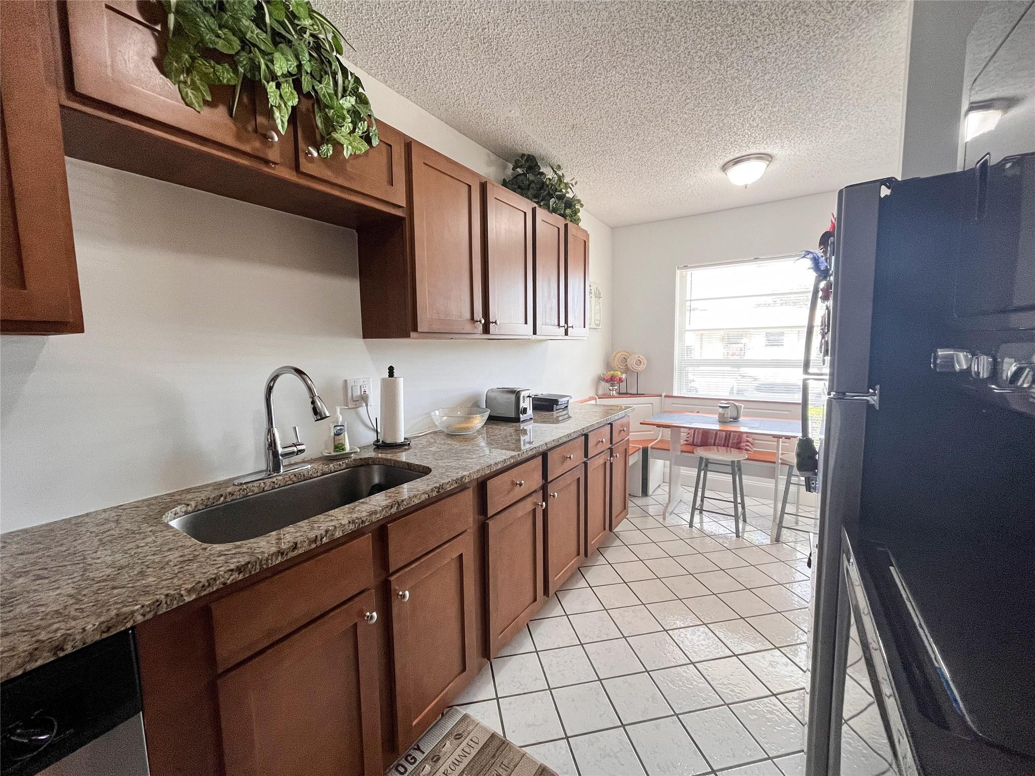 20932 Sedgewick Drive, Unit 400 Boca Raton, FL 33433 - Photo 14 of 34 a kitchen with stainless steel appliances granite countertop a sink stove and cabinets