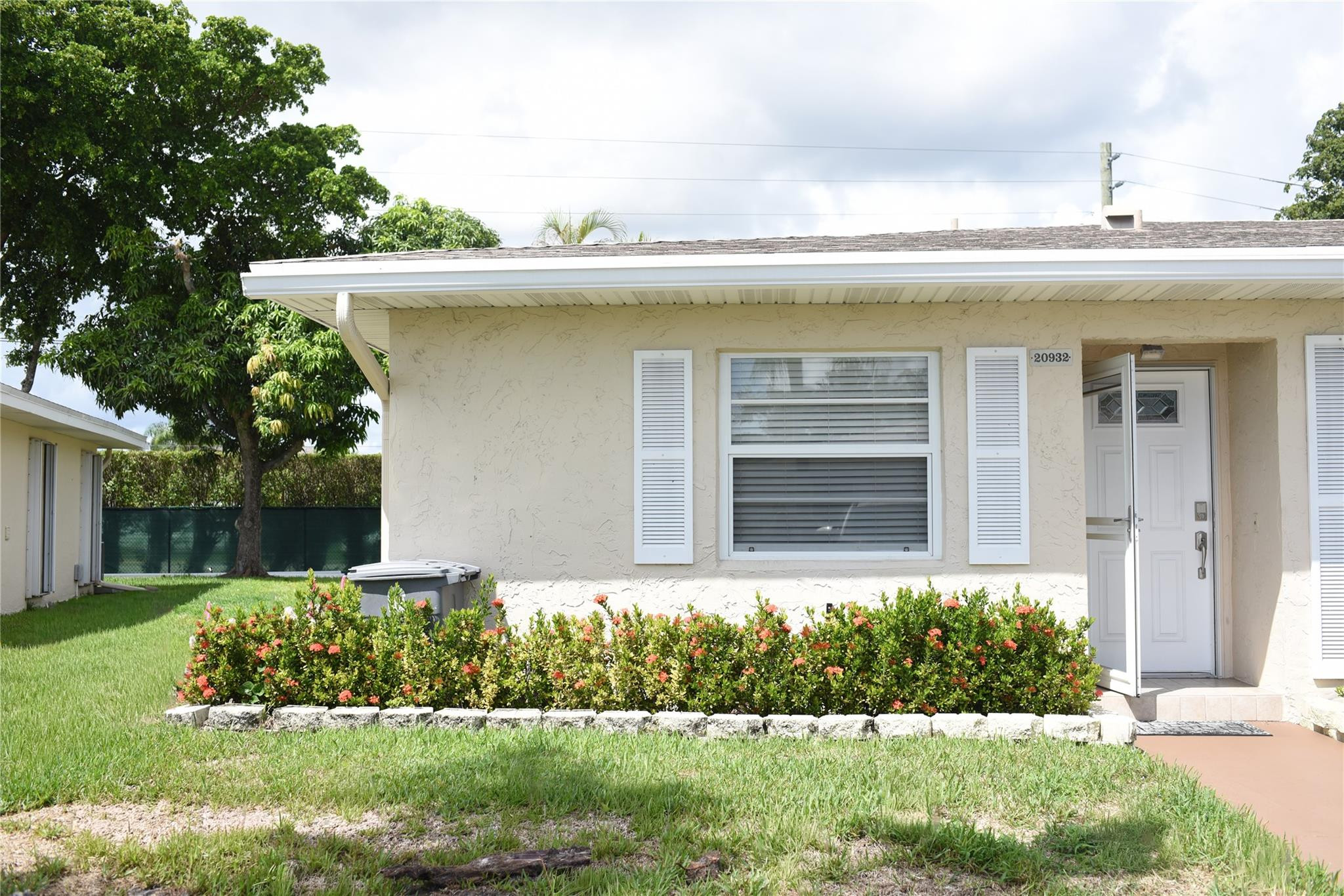 20932 Sedgewick Drive, Unit 400 Boca Raton, FL 33433 - Photo 2 of 34 a front view of a house with a yard