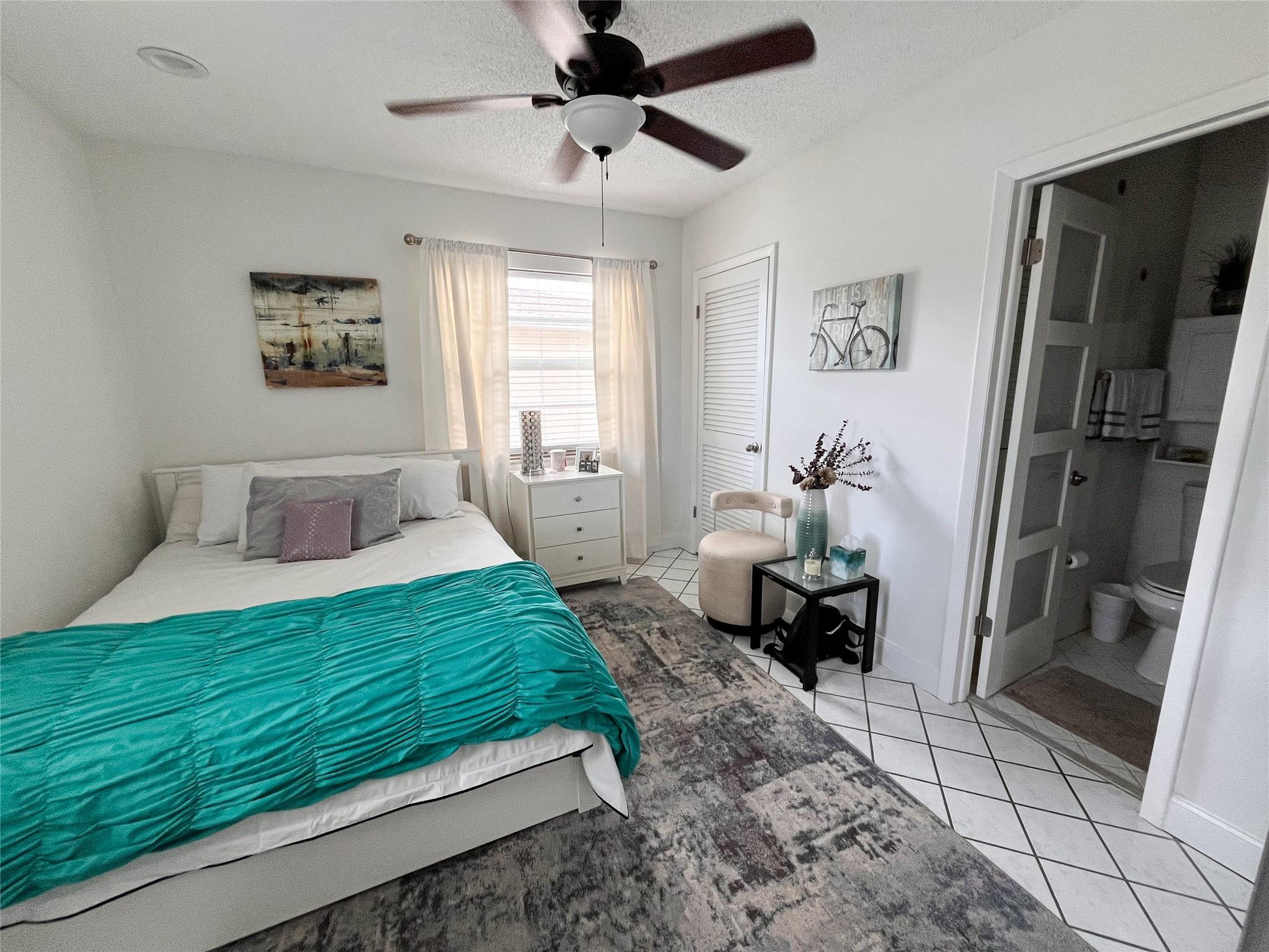 20932 Sedgewick Drive, Unit 400 Boca Raton, FL 33433 - Photo 21 of 34 a bedroom with a bed and a chandelier