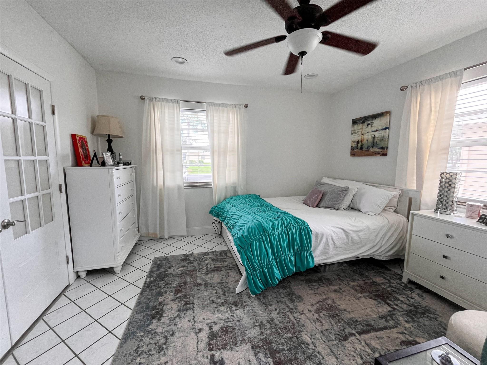 20932 Sedgewick Drive, Unit 400 Boca Raton, FL 33433 - Photo 22 of 34 a spacious bedroom with a bed and a window