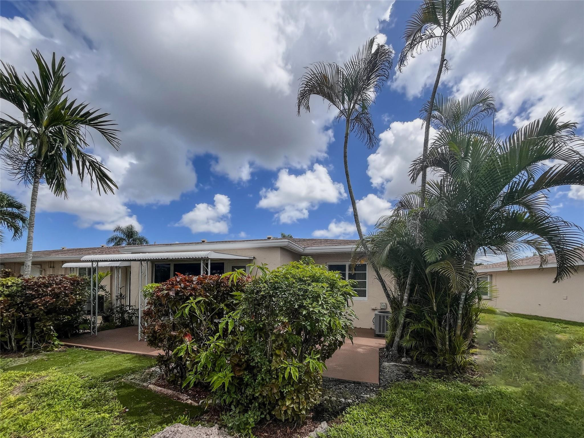 20932 Sedgewick Drive, Unit 400 Boca Raton, FL 33433 - Photo 27 of 34 a view of a house with a yard and potted plants