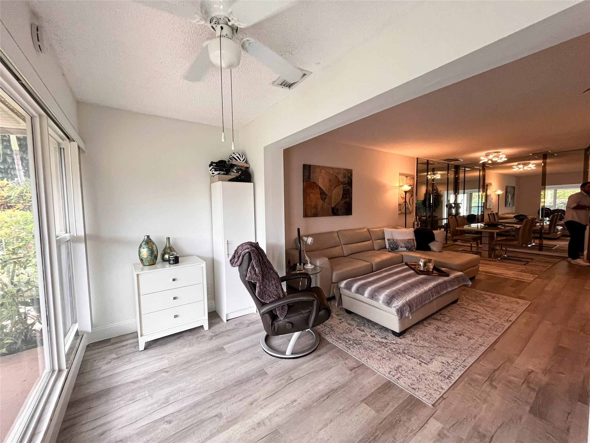 20932 Sedgewick Drive, Unit 400 Boca Raton, FL 33433 - Photo 6 of 34 a living room with furniture gym equipment and a large window