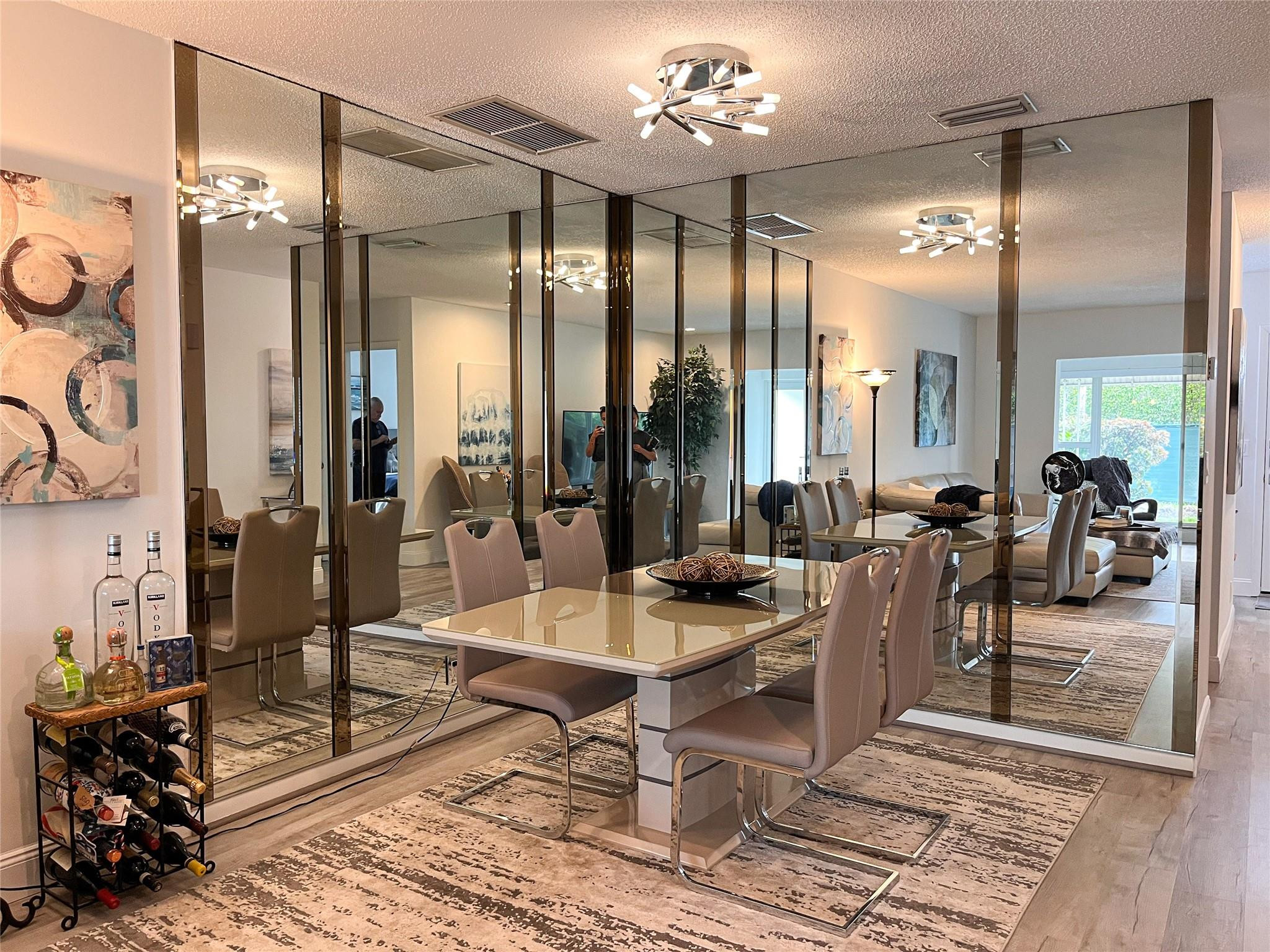 20932 Sedgewick Drive, Unit 400 Boca Raton, FL 33433 - Photo 8 of 34 a living room with furniture a chandelier and a table