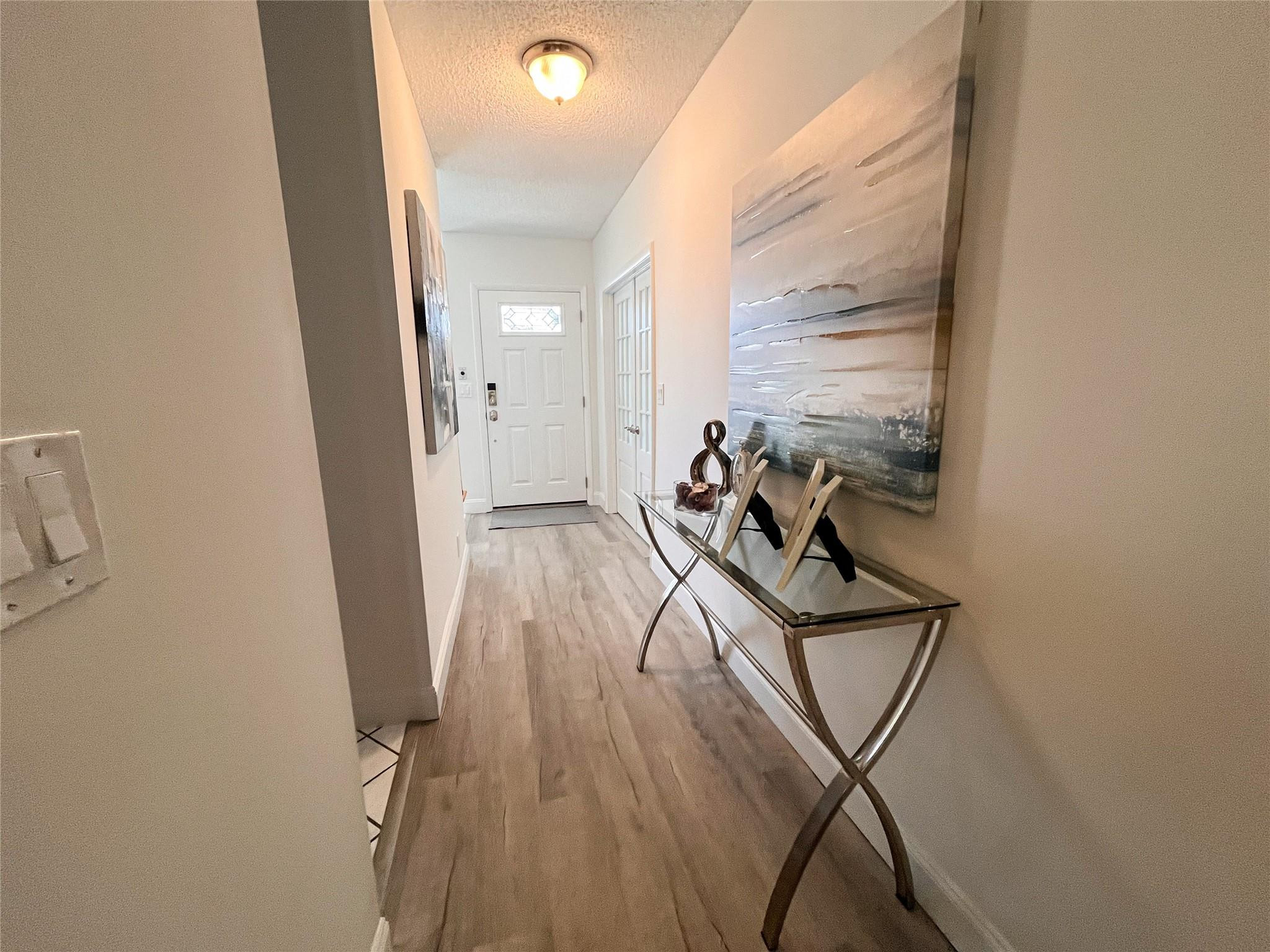 20932 Sedgewick Drive, Unit 400 Boca Raton, FL 33433 - Photo 9 of 34 an entryway of a house with wooden floor