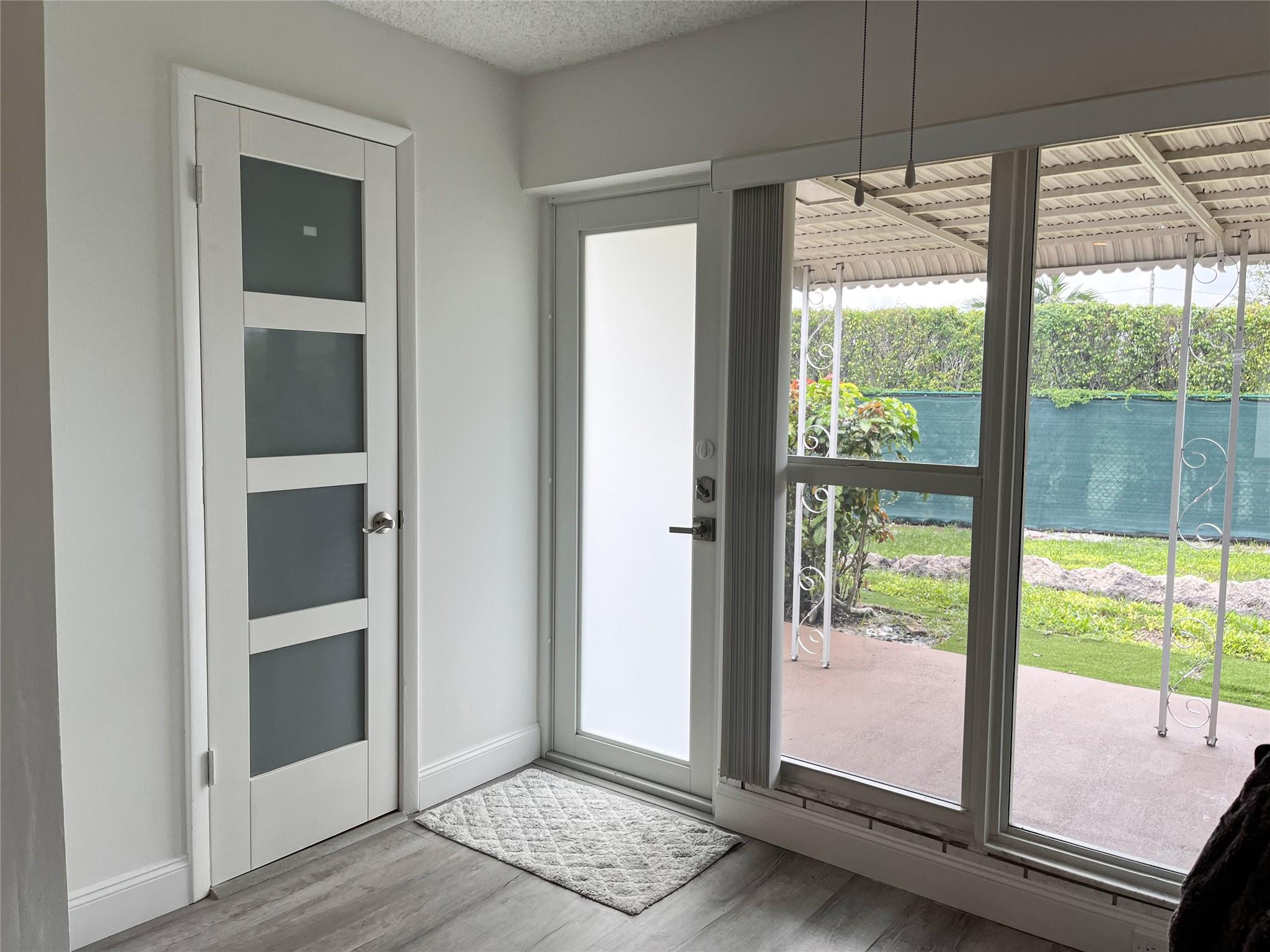 20932 Sedgewick Drive, Unit 400 Boca Raton, FL 33433 - Photo 10 of 34 a view of an empty room with a window and wooden floor