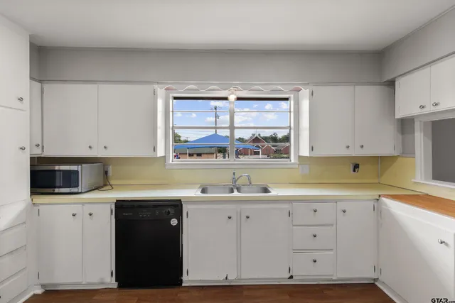 a kitchen with a stove and a wooden floor