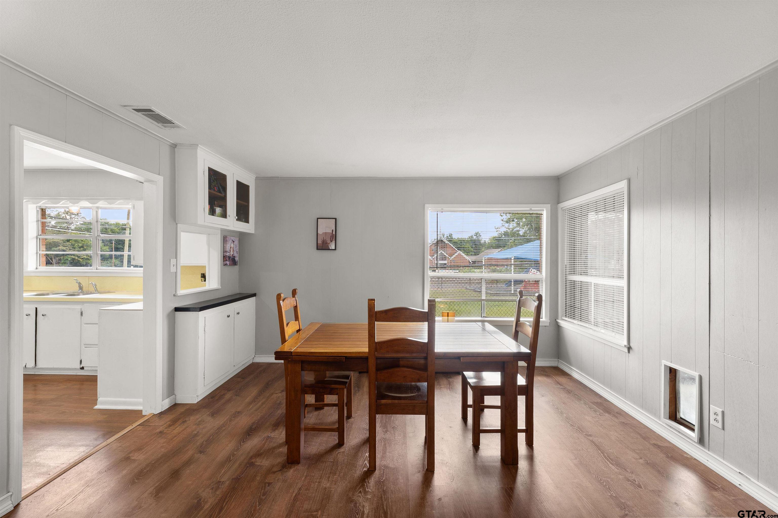 910 West Vance Street Tyler, TX 75702 - Photo 17 of 26 a view of a dining room with furniture window and wooden floor