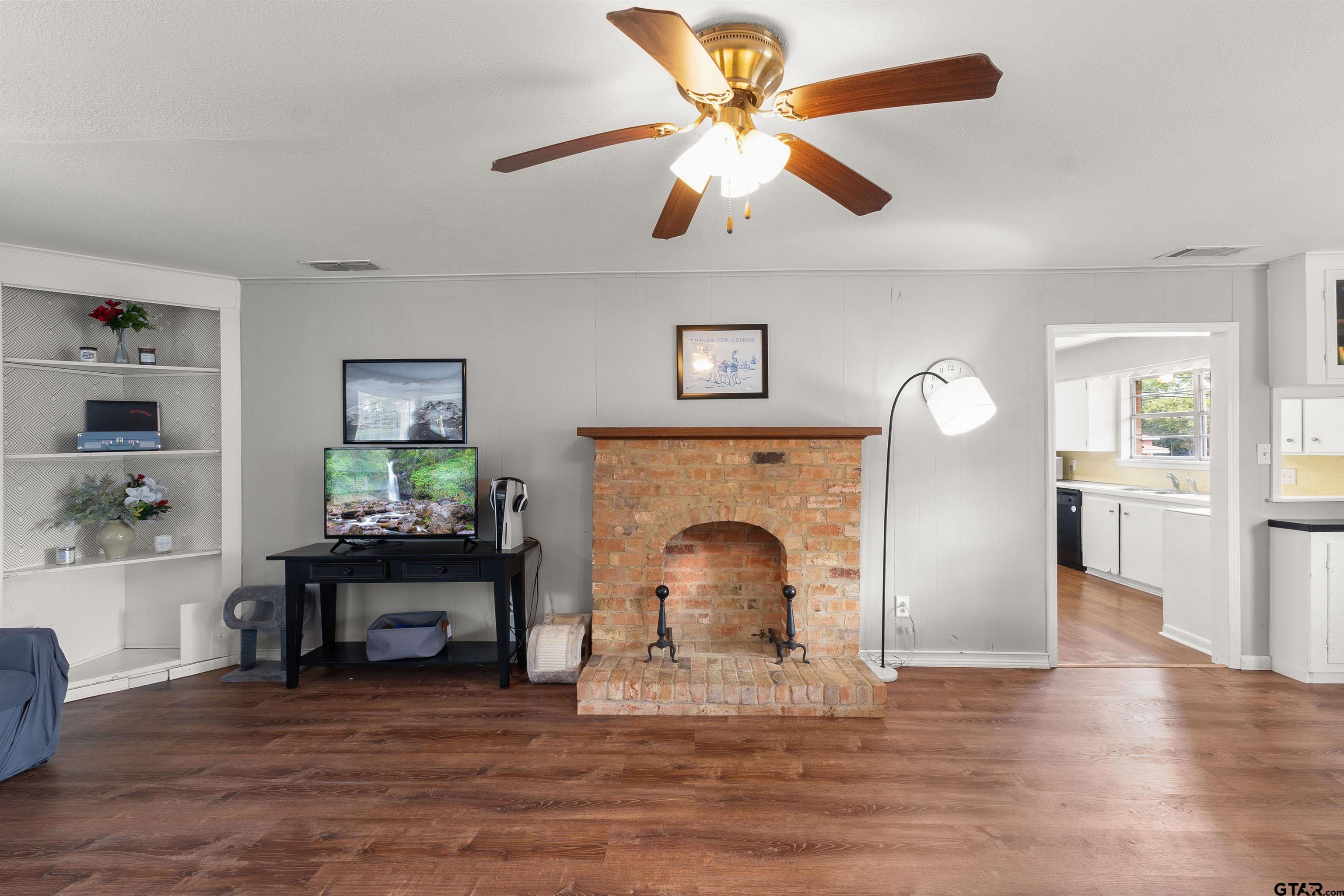 910 West Vance Street Tyler, TX 75702 - Photo 18 of 26 a living room with furniture and a fireplace