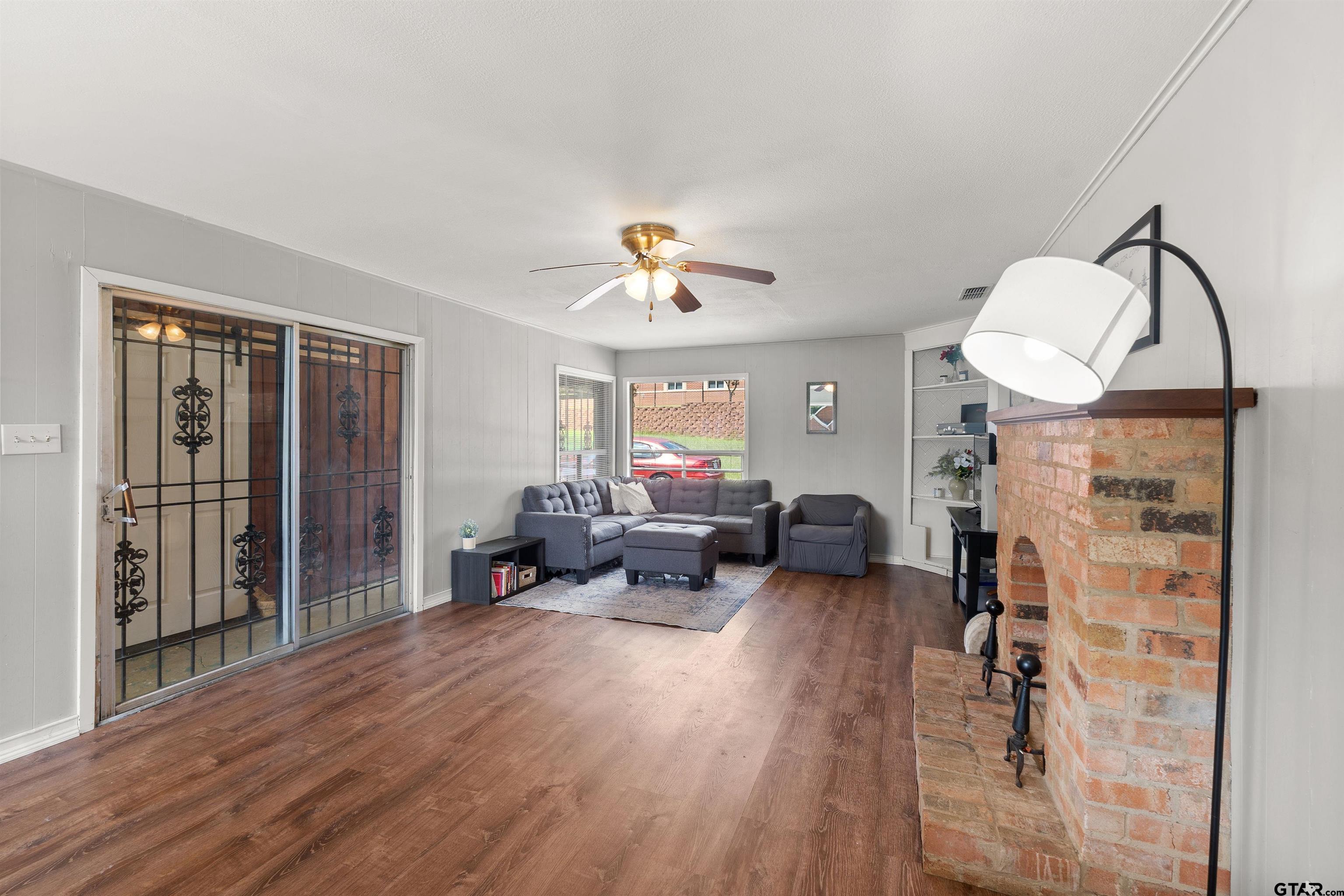 910 West Vance Street Tyler, TX 75702 - Photo 19 of 26 a living room with furniture and a fireplace