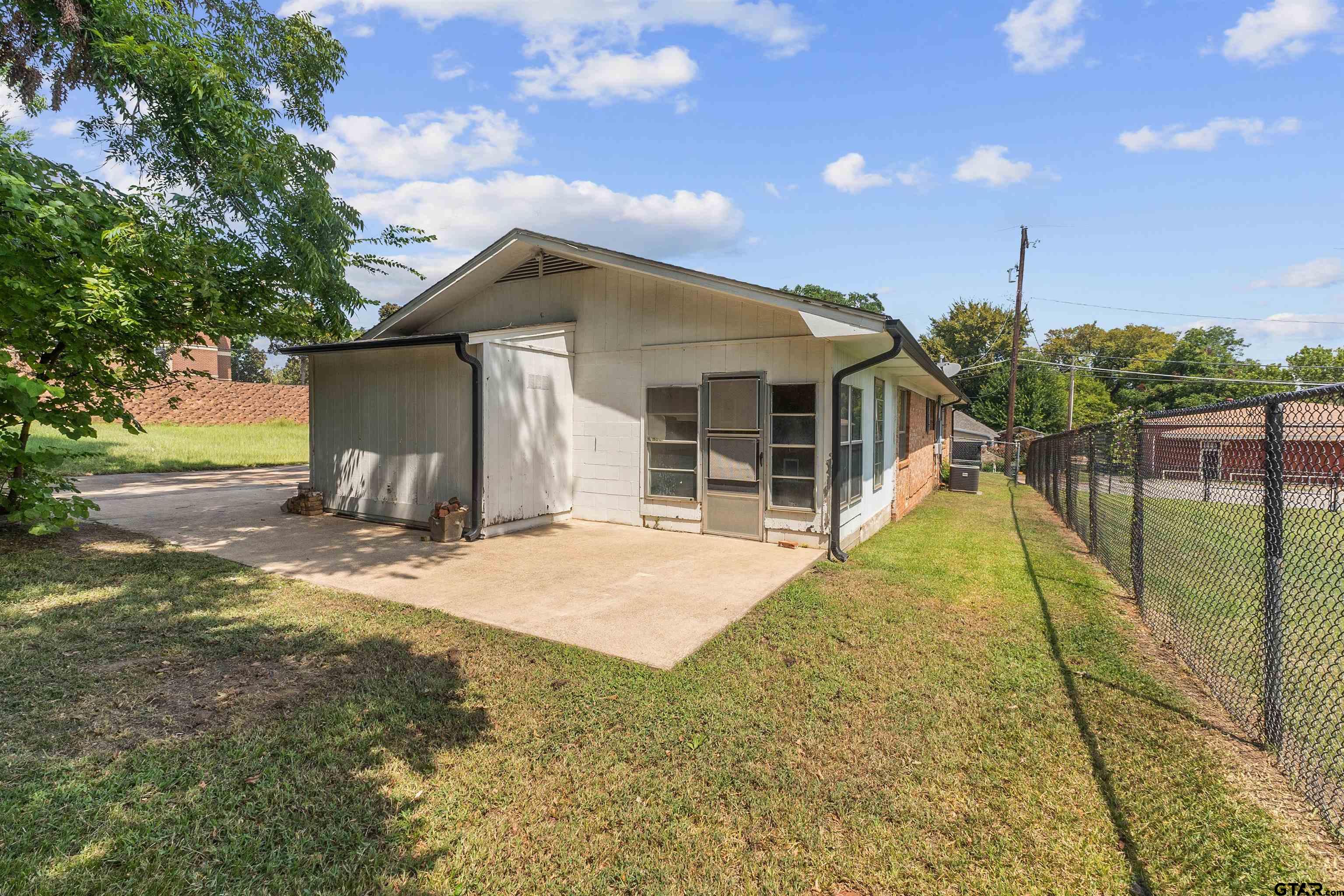 910 West Vance Street Tyler, TX 75702 - Photo 21 of 26 a view of a house with a backyard