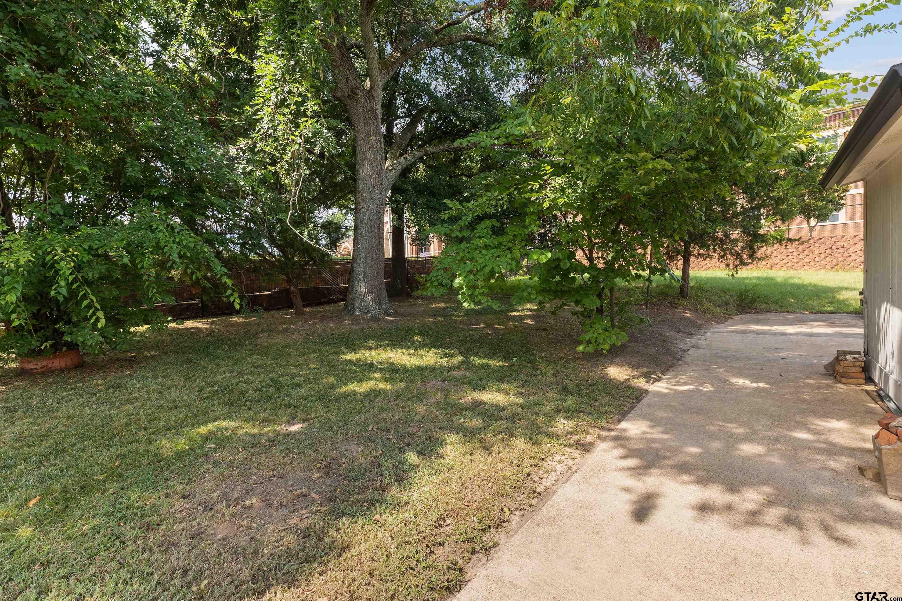 910 West Vance Street Tyler, TX 75702 - Photo 22 of 26 a view of a yard with a tree