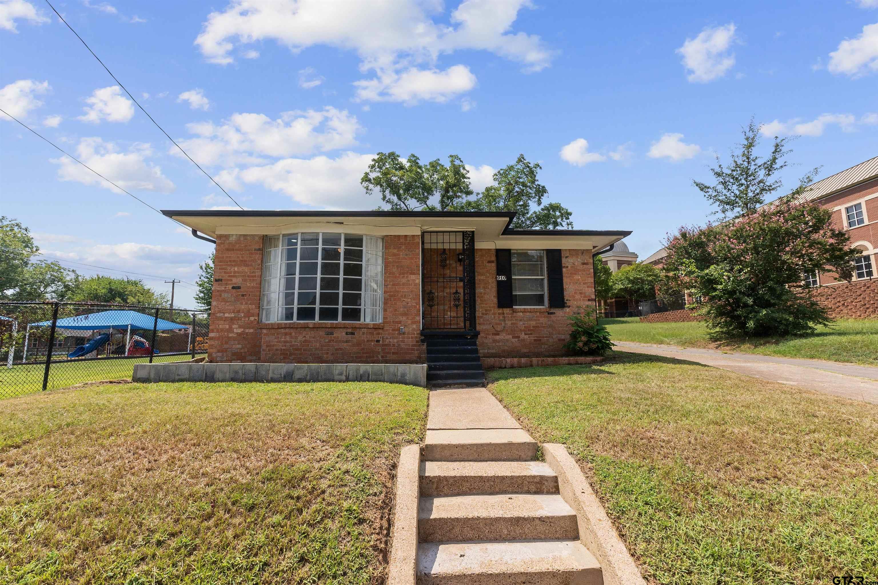 910 West Vance Street Tyler, TX 75702 - Photo 25 of 26 a front view of a house with a yard