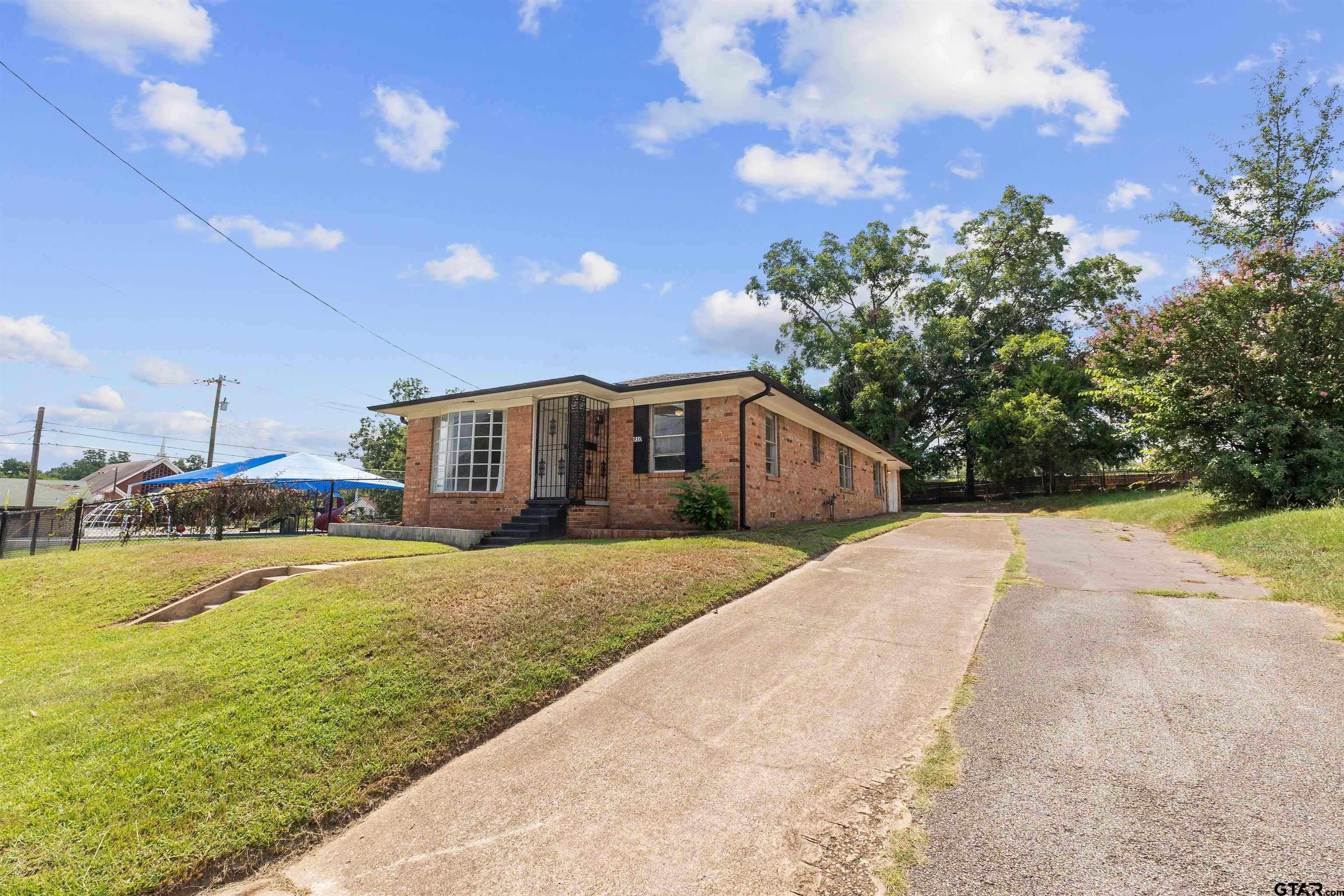 910 West Vance Street Tyler, TX 75702 - Photo 26 of 26 a front view of a house with a yard