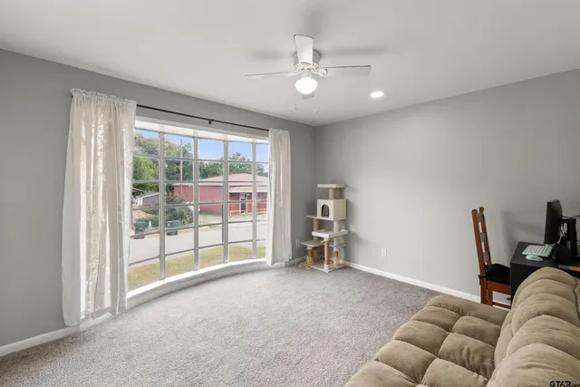 a living room with furniture and a floor to ceiling window