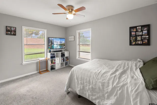 a bed sitting in a bedroom next to a window