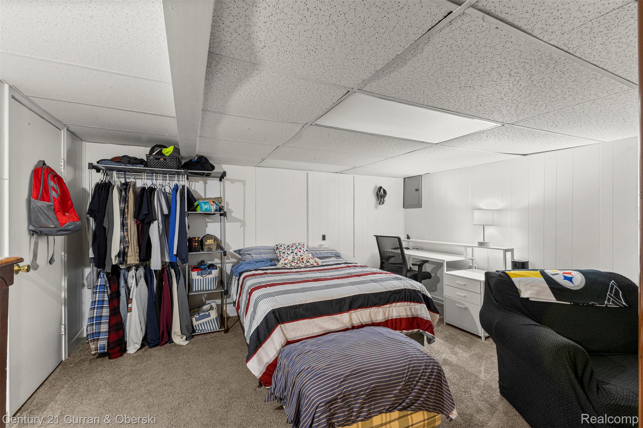 31083 Hoover Road, Unit 12 Warren, MI 48093 - Photo 30 of 39 Carpeted room featuring white paneled walls and a drop ceiling with integrated lighting