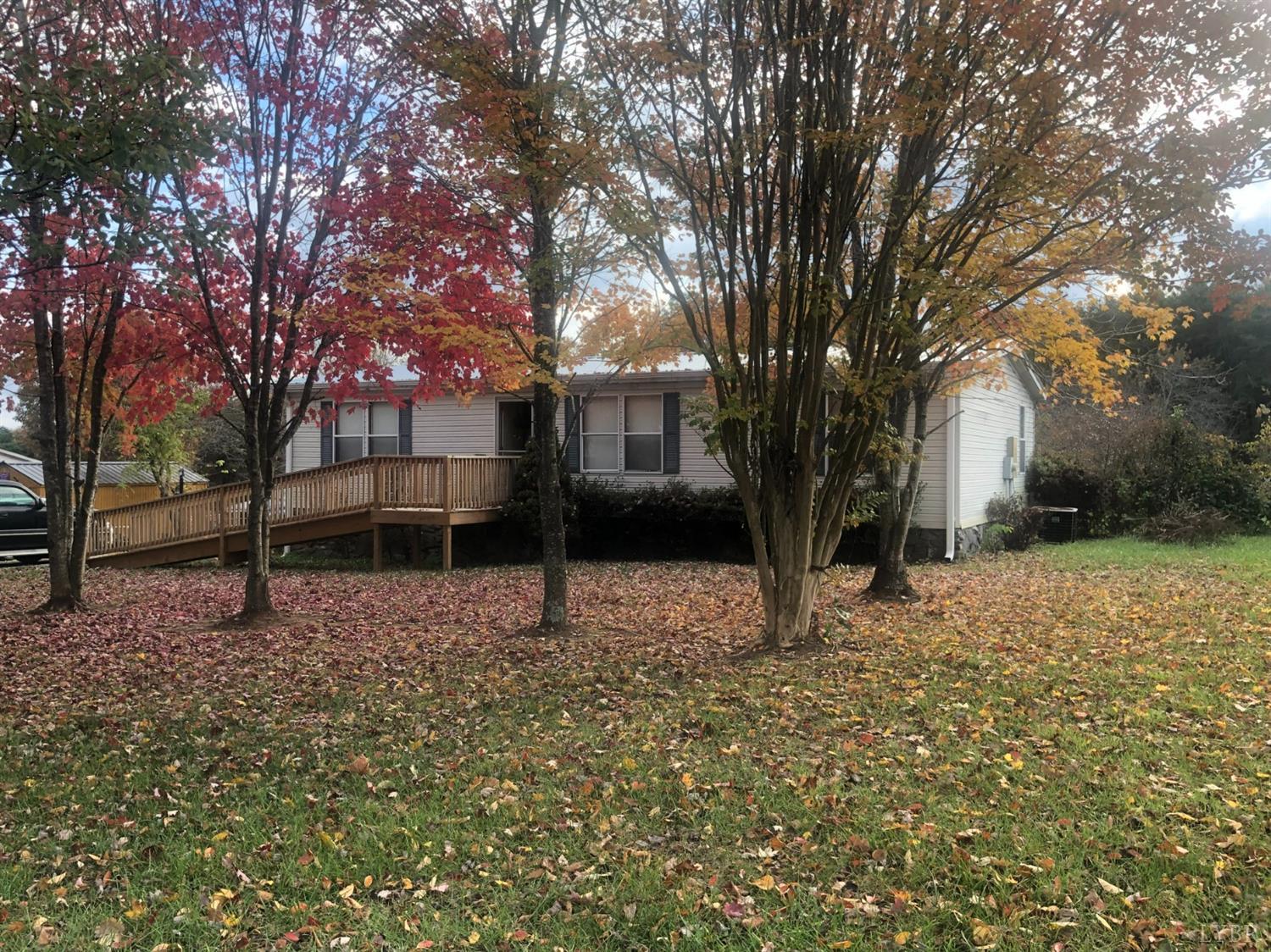 55 Carwile Road Rustburg, VA 24588 - Photo 4 of 10 a house with trees in front of it