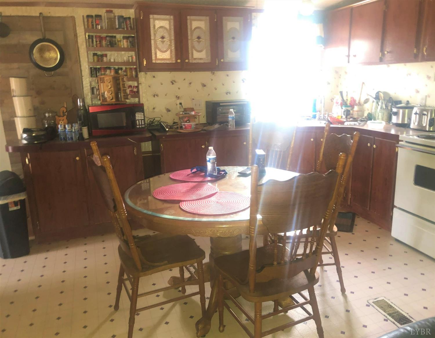 55 Carwile Road Rustburg, VA 24588 - Photo 6 of 10 a dining room with furniture and wooden floor