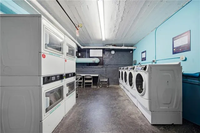 a front view of a residential apartment building with a yard and plants