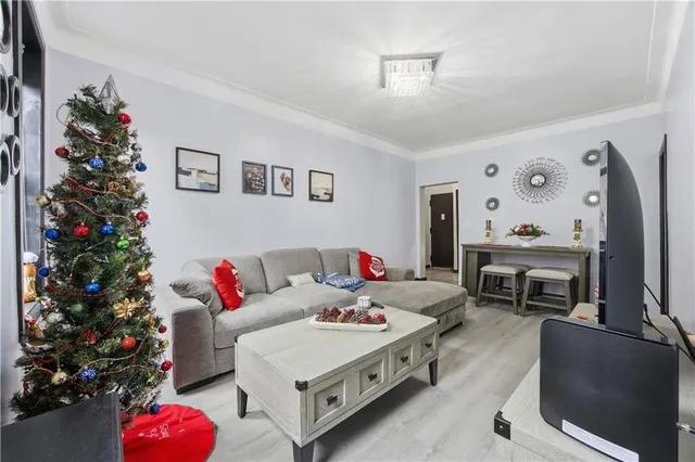 a living room with furniture and flowers