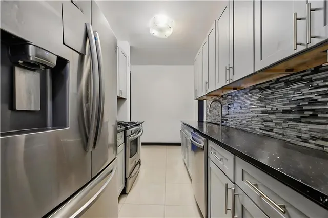 a kitchen with stainless steel appliances a refrigerator stove and microwave