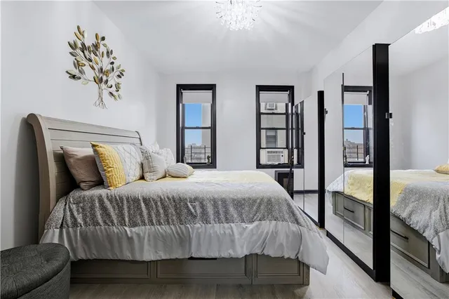 a bedroom with a bed and a chandelier