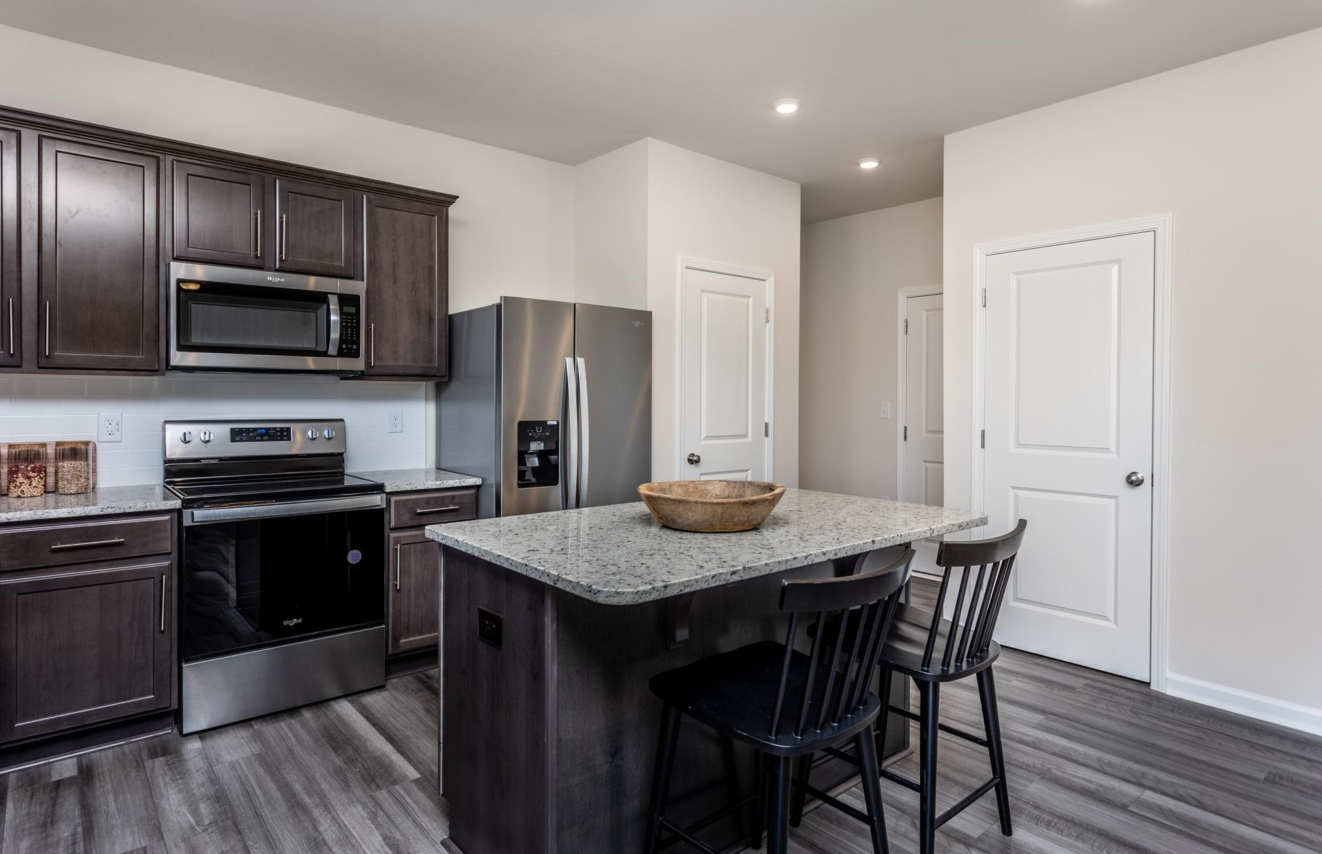 1725 Luna Way Raleigh, NC 27604 - Photo 11 of 19 a kitchen with a wooden floor and stainless steel appliances