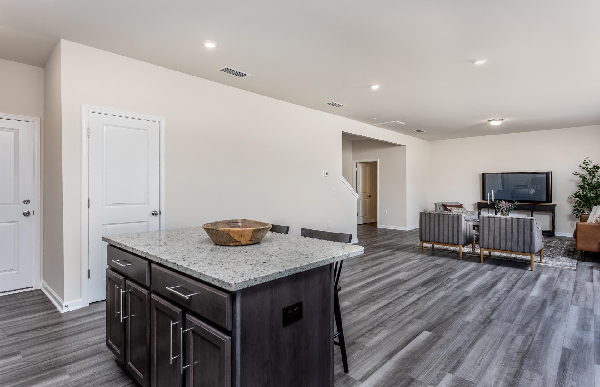 1725 Luna Way Raleigh, NC 27604 - Photo 10 of 19 a kitchen with granite countertop a stove and a wooden floor