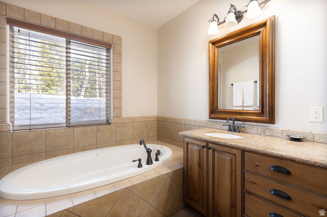 382 Ridgeview Street, Unit 8 & 9 Brian Head, UT 84719 - Photo 36 of 52 Soaking tub surrounded by tile, featuring a window with wooden blinds
