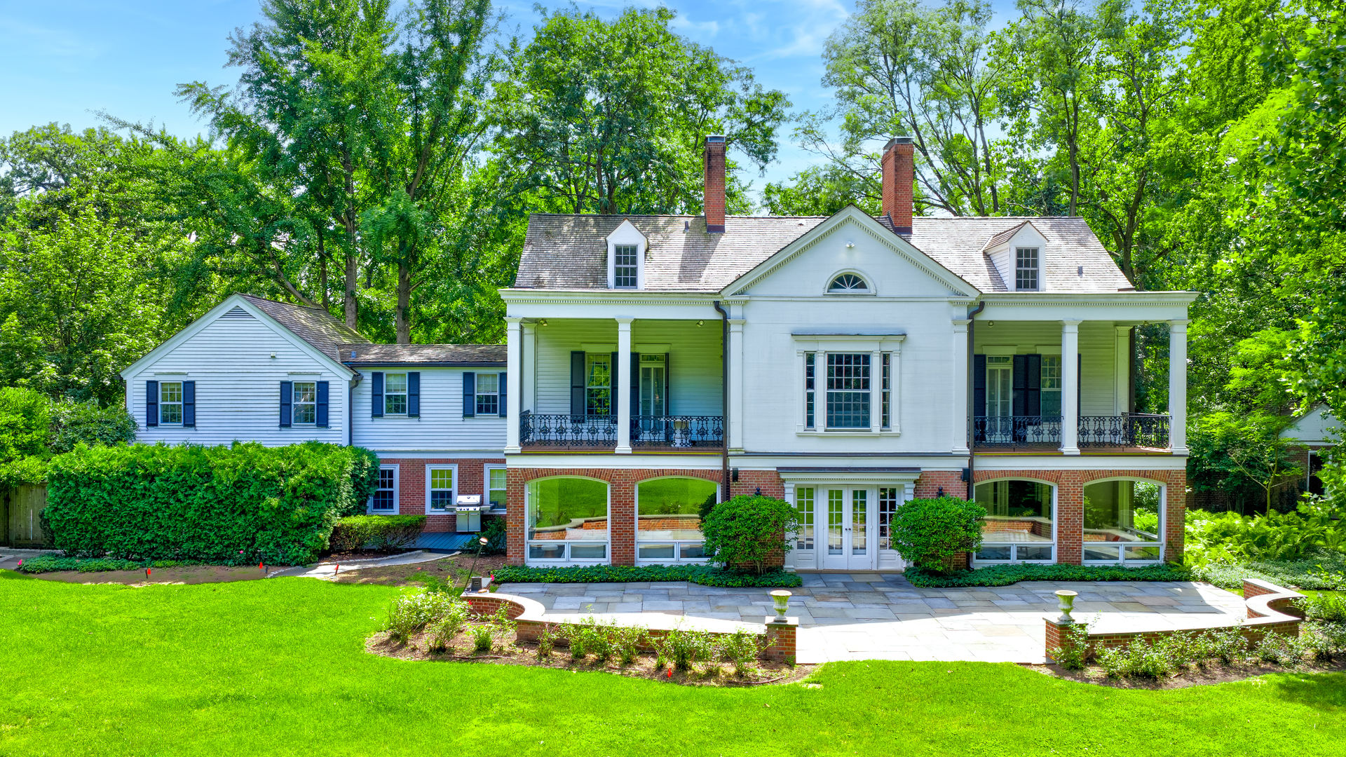 62 Woodley Road Winnetka, IL 60093 - Photo 1 of 43 a front view of a house with garden and trees