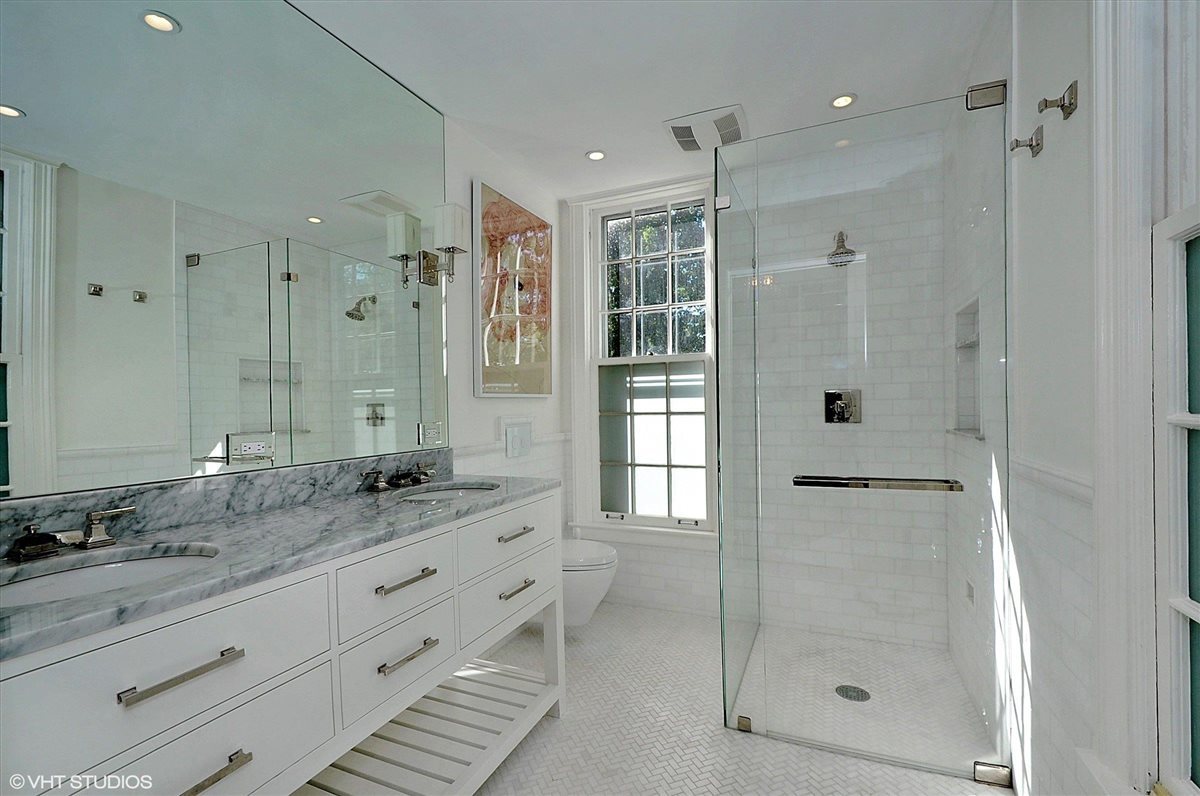 62 Woodley Road Winnetka, IL 60093 - Photo 26 of 43 a bathroom with a shower sink and mirror