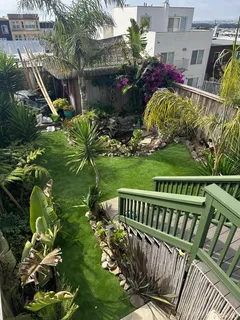 a view of a deck with furniture and garden