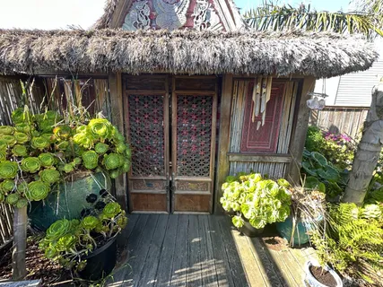 a front view of a house with a lot of flowers