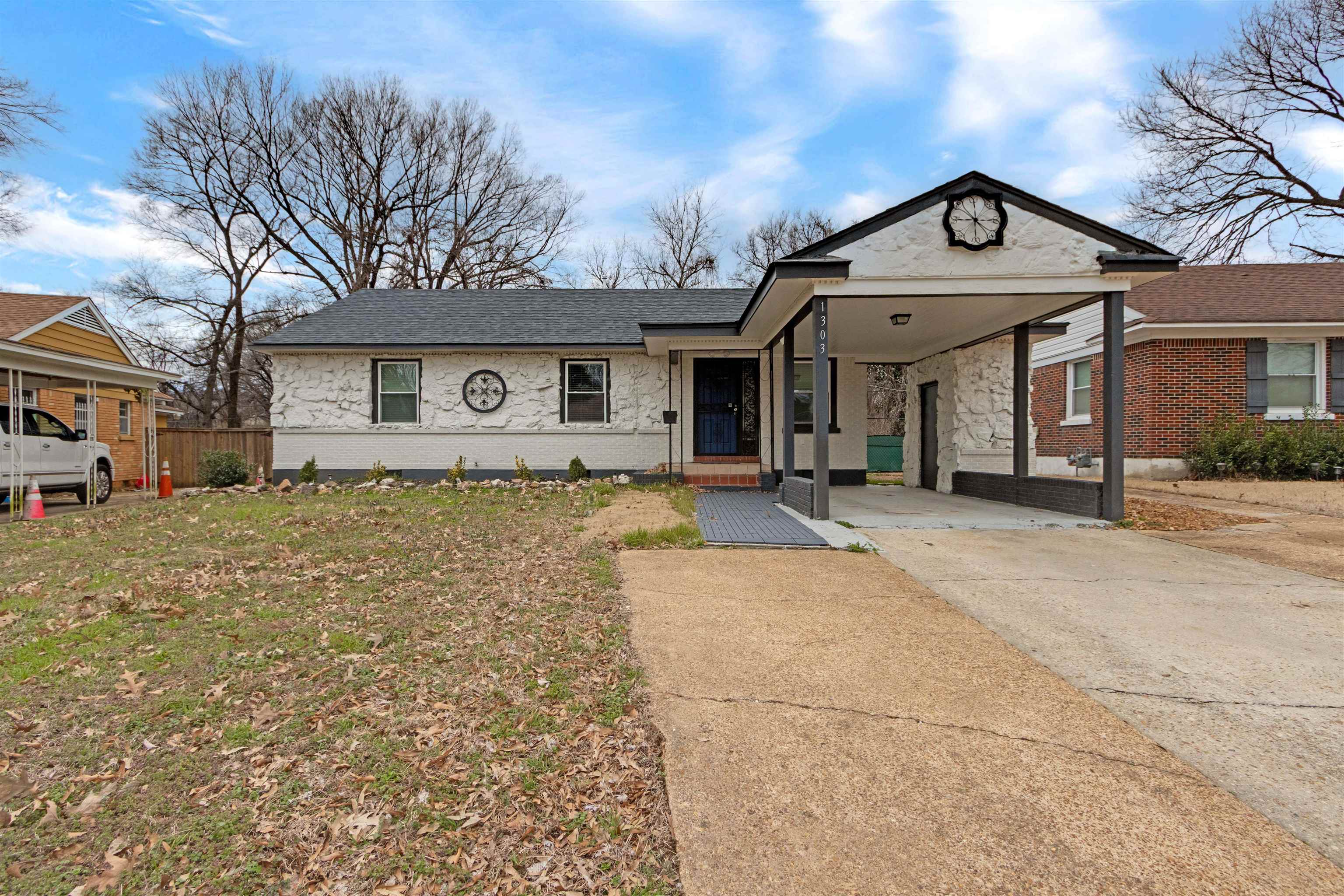 1303 Inman Road Memphis, TN 38111 - Photo 1 of 12 View of front facade featuring fence, brick siding, concrete driveway, and a shingled roof