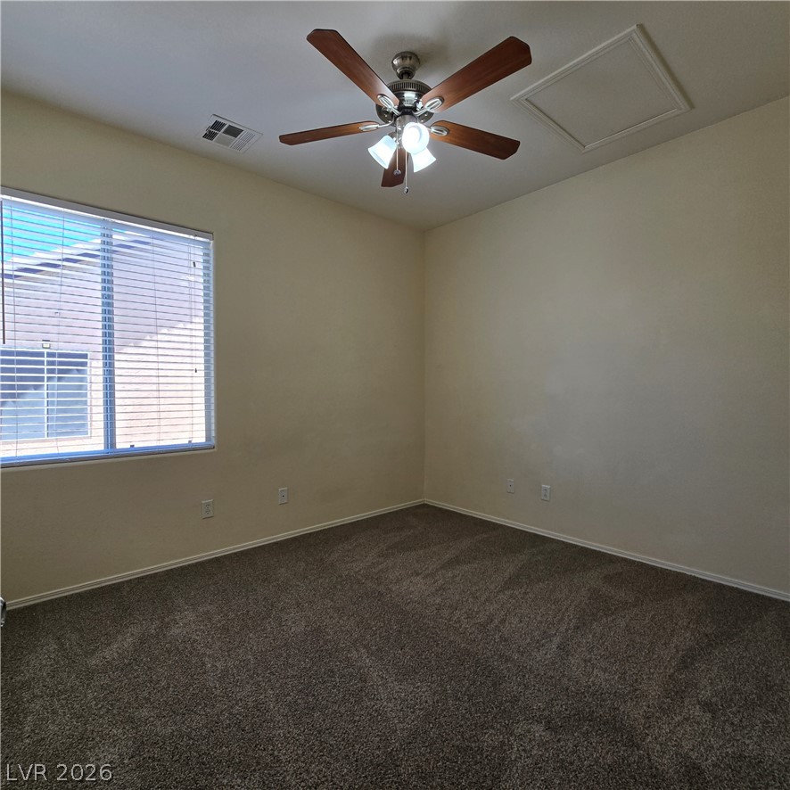 9234 Kingston Road Henderson, NV 89074 - Photo 21 of 38 A well-lit bedroom awaits, featuring comfortable carpet flooring and a ceiling fan for year-round comfort.