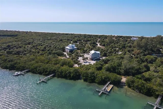 a bathroom with a toilet sink and painting on the wall