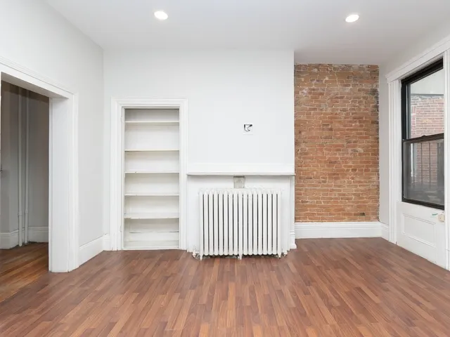 a view of a room with wooden floor and windows