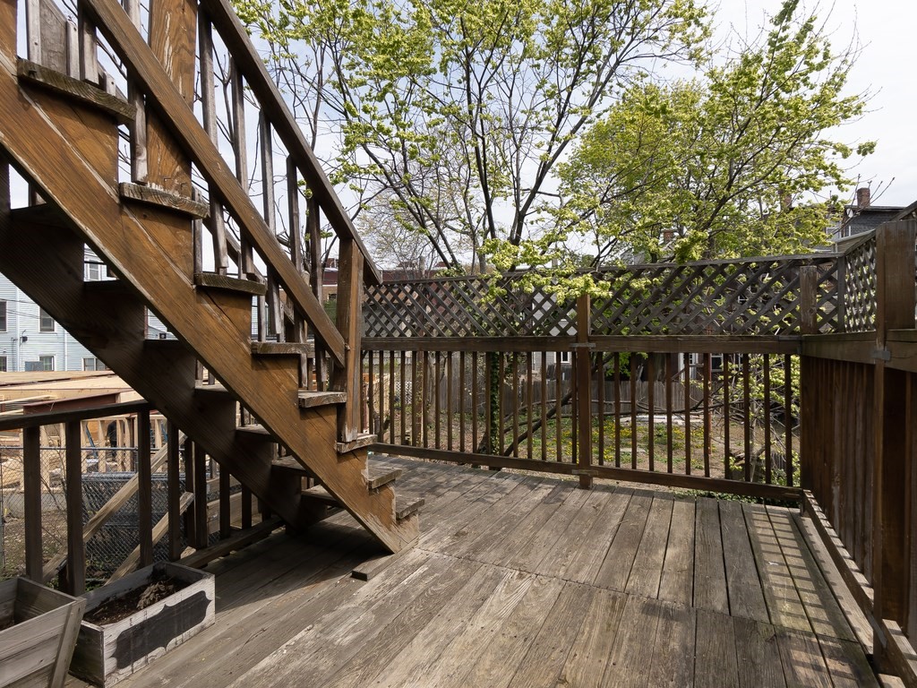 289 Meridian Street, Unit 2 Boston, MA 02128 - Photo 14 of 16 a view of balcony with wooden floor and fence