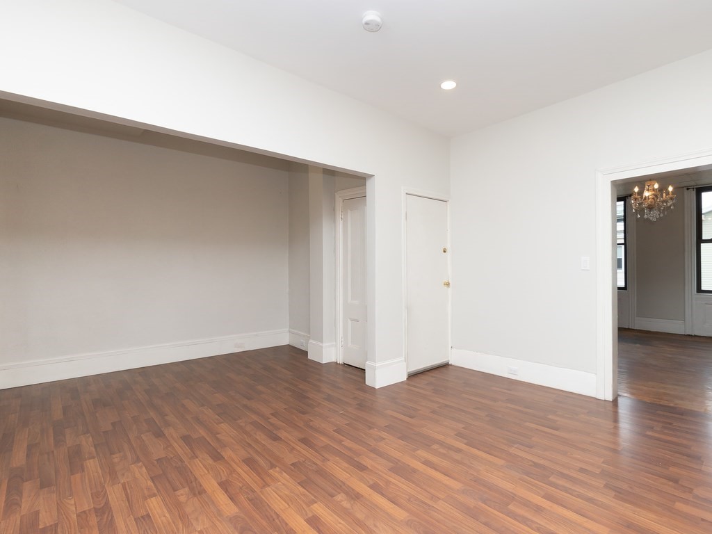 289 Meridian Street, Unit 2 Boston, MA 02128 - Photo 2 of 16 a view of an empty room with wooden floor