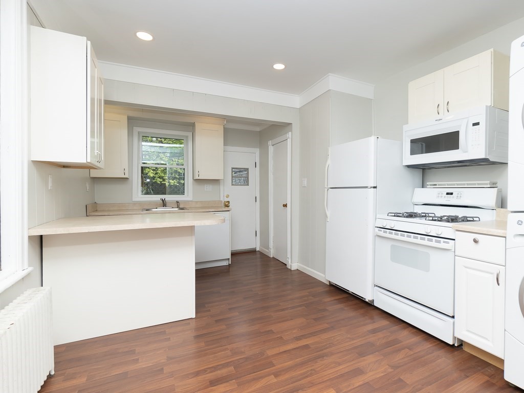 289 Meridian Street, Unit 2 Boston, MA 02128 - Photo 5 of 16 a kitchen with white cabinets and white appliances