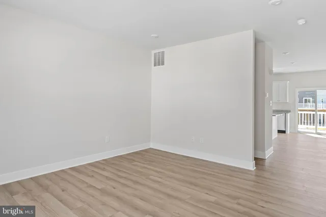 a view of a room with wooden floor